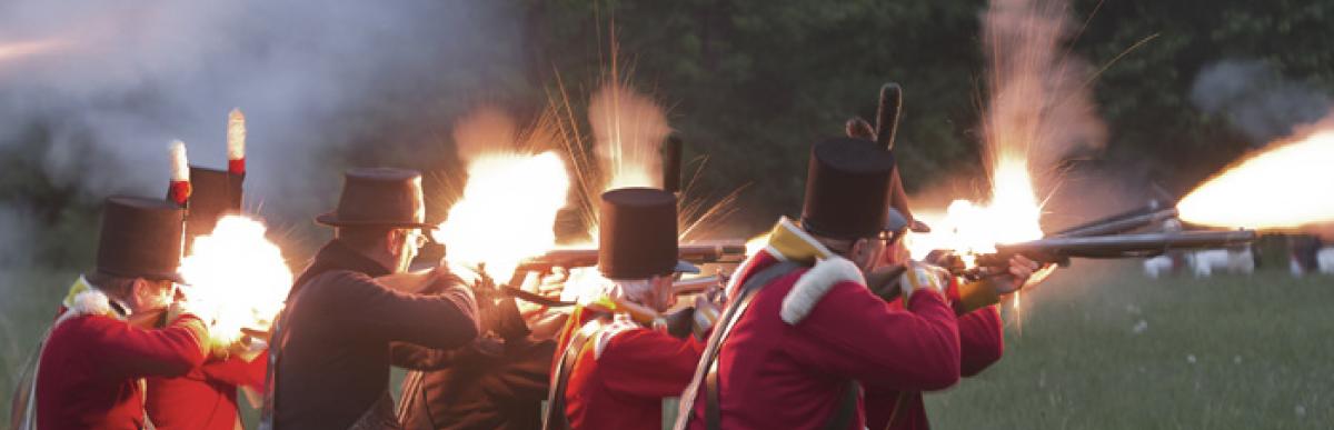 Re-enactors shooting guns