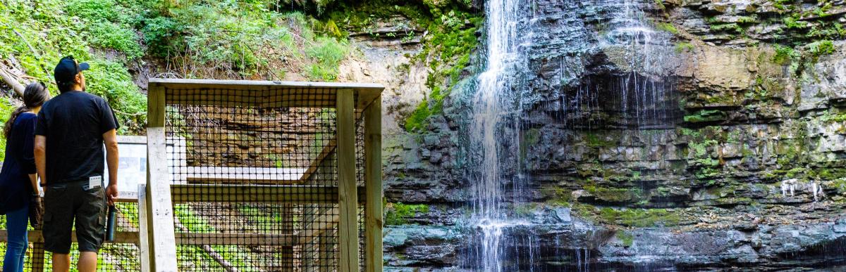 Two people standing on the observation deck at Tiffany Falls Conservation Area