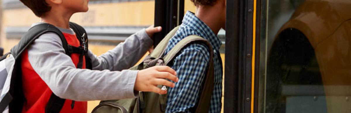 Back to school safety - kids getting onto a yellow school bus