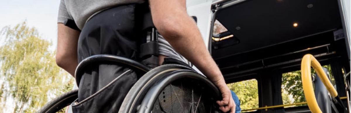 Man in wheelchair boarding public transport