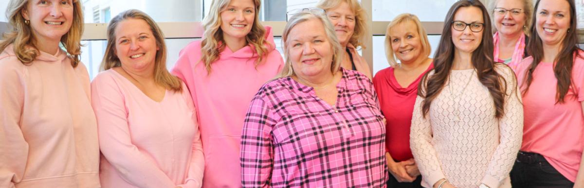 Pink Shirt Day - several women in pink shirts smiling at the camera