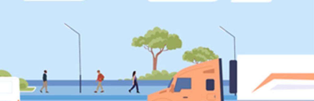 Cars, trucks and bicycles on the street and pedestrians on the sidewalk