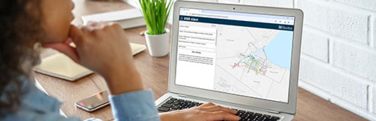 Woman browsing HSR real time alerts map on laptop