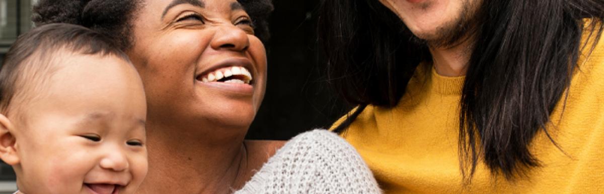 parents holding baby