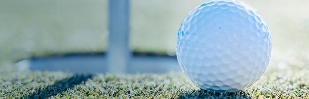 Close up of golf ball and hole