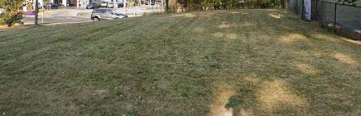 Grass covered empty lot for 64 East 31st Street