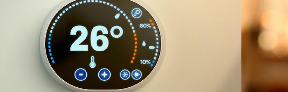 Thermostat on wall showing 26 degrees