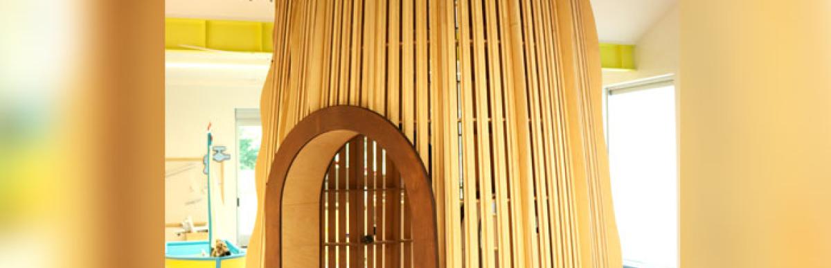Wooden tree play structure inside of the Hamilton Children's Museum