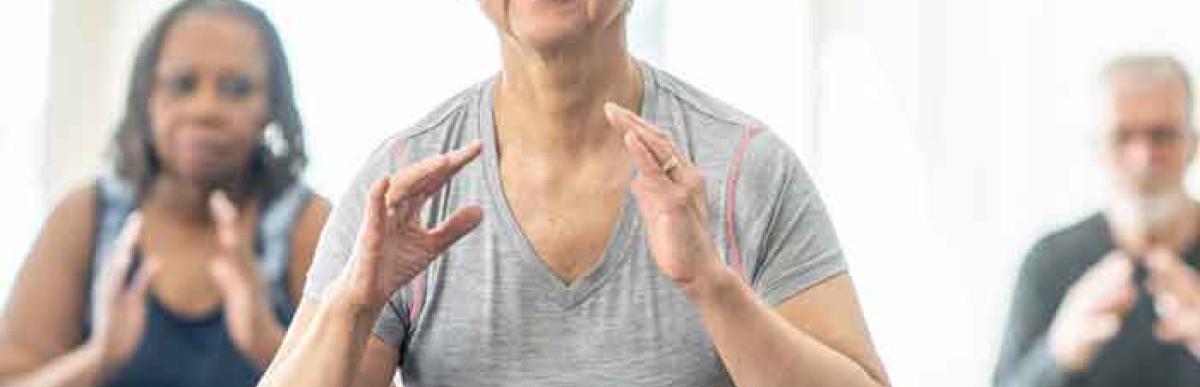 Three seniors exercising at an indoor gym