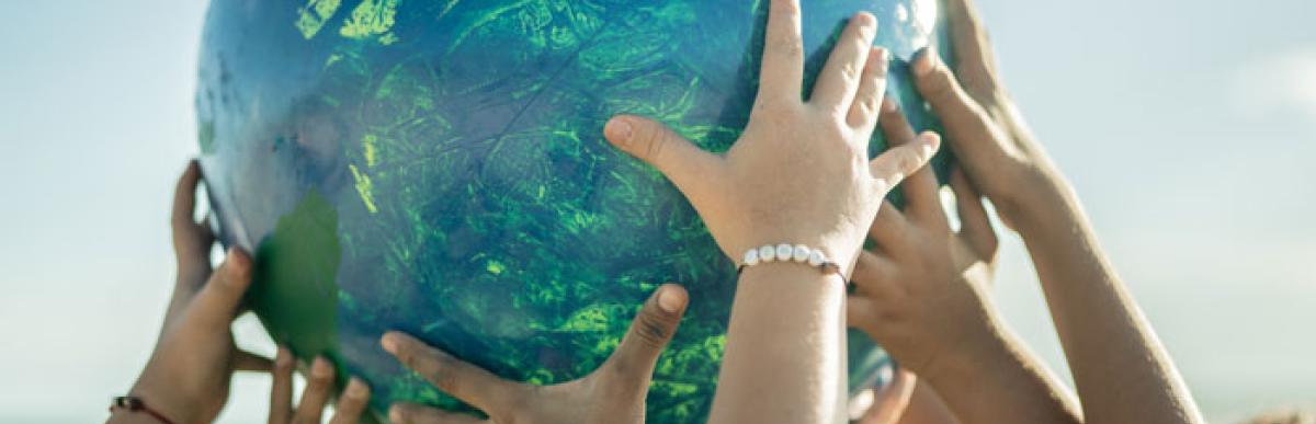 hands holding up an earth