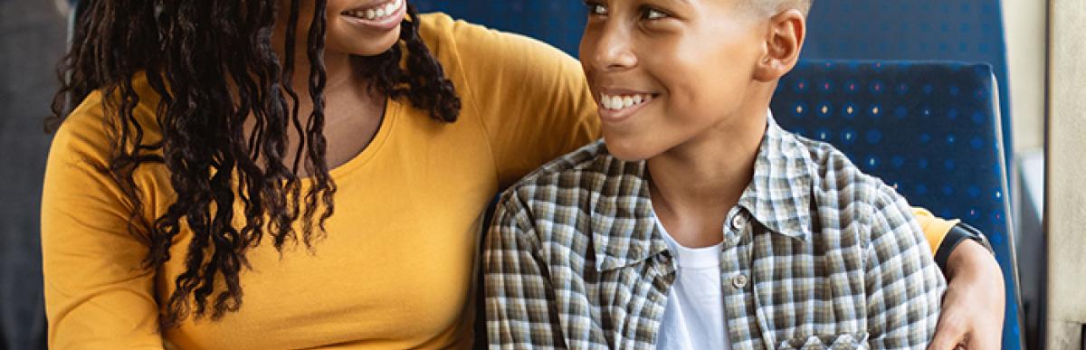 woman sitting with child on bus