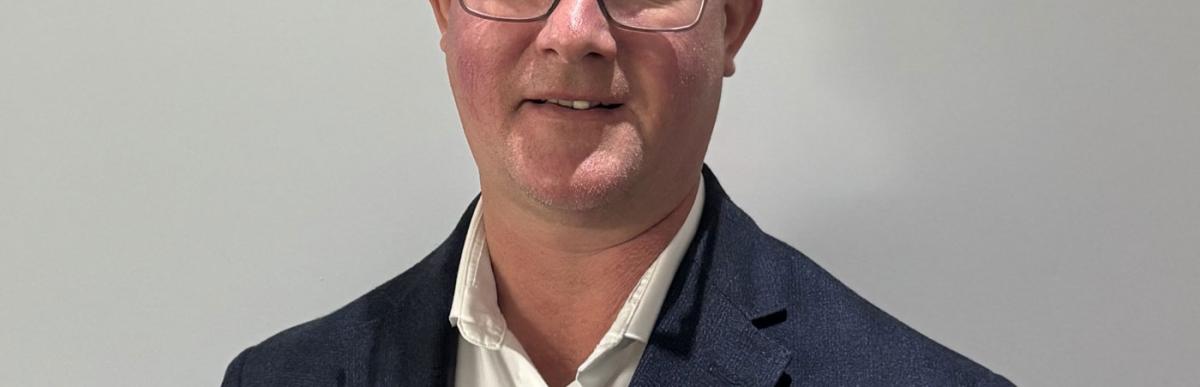 Head and shoulders of Brian Hollingworth, middle-aged white male with glasses and short greying hair