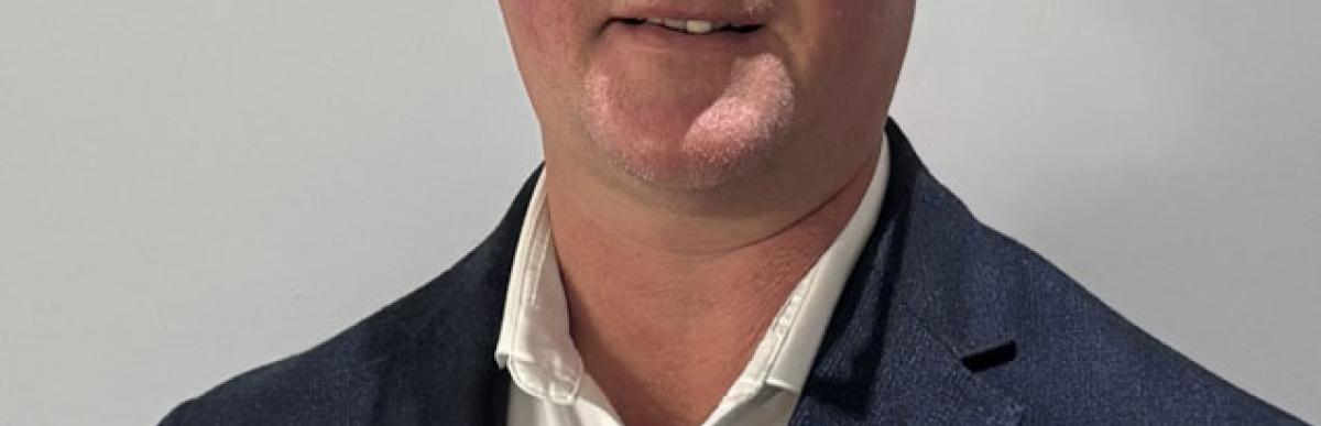 Head and shoulders of Brian Hollingworth, middle-aged white male with glasses and short greying hair