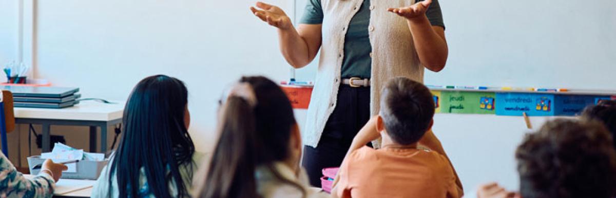 Teacher standing in front of elementary students in a classroom