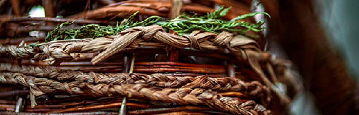 Right to Repossess sculpture is made out of willow, a cedar post, corn husk, wood, clay, material, and ribbon