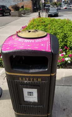 Ashtray on top of sidewalk garbage can