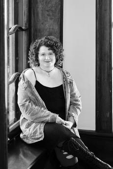 woman sitting on window sill