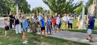 group of people on a walking tour in a cemetery