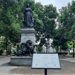 Queen Victoria statue with contextual sign