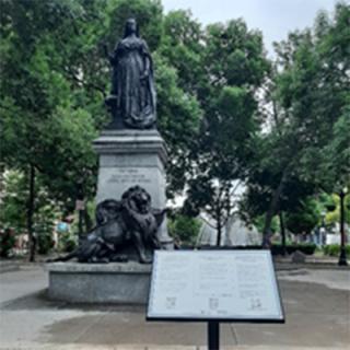 Queen Victoria statue with contextual sign