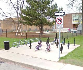 bikes locked at racks in front of school