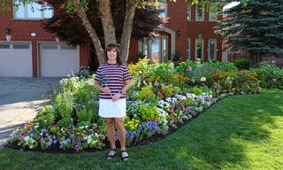 winner standing in front of their garden